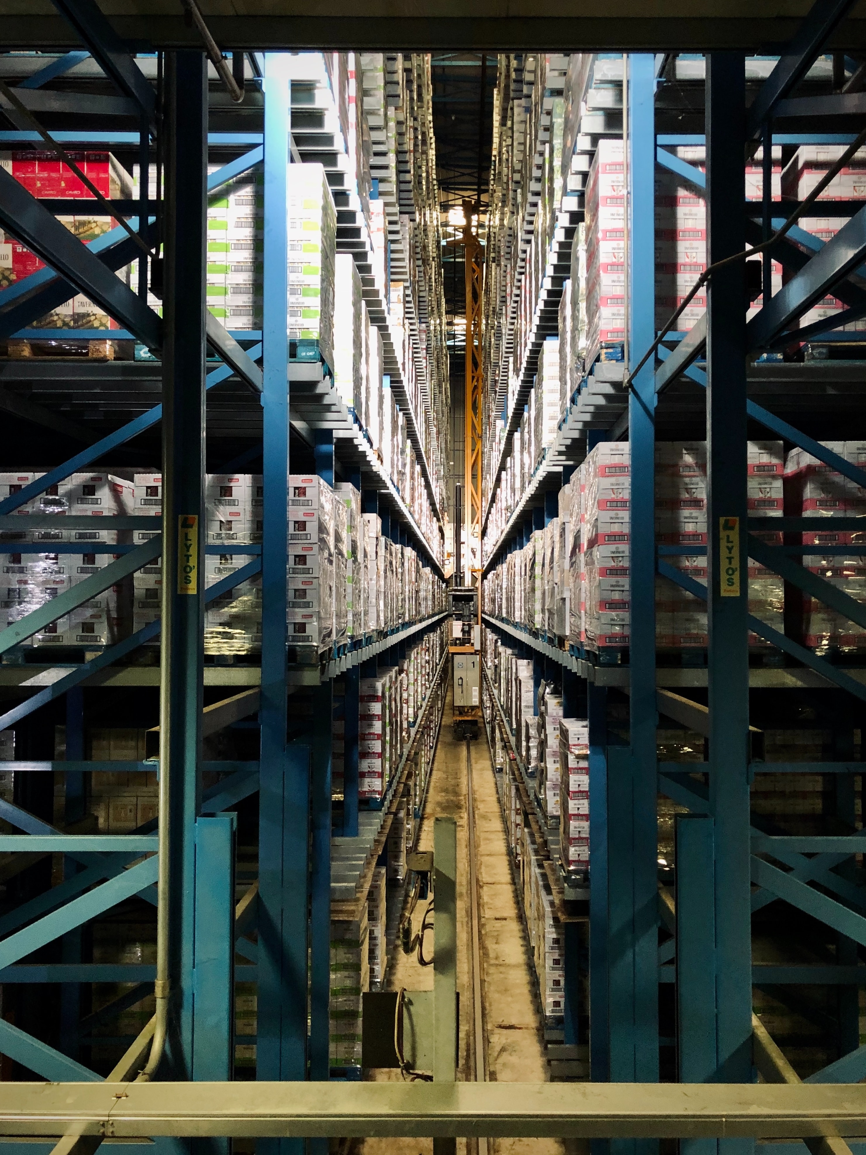 full pallets stacked on blue warehouse racks